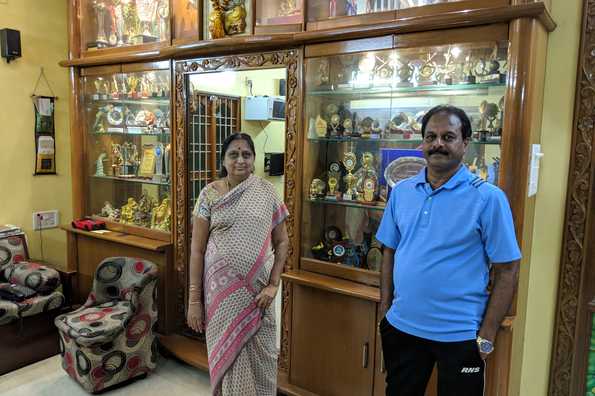 Vijay's parents pose in front of his trophy cabinet. Vijay's parents pose in front of his trophy cabinet.
