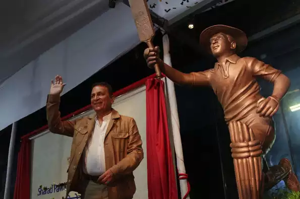 Sunil Gavaskar posing with his life-size statue Sunil Gavaskar posing with his life-size statue